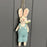 Spring Rabbit in Blue Dungarees Holding Flowers