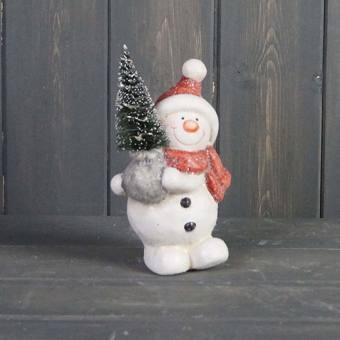 Snowman Holding A Light Up Tree to the left